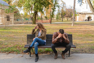 A frustrated couple sitting on the bench