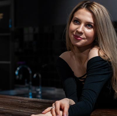 A photo of a Russian woman wearing a black long sleeve shirt.