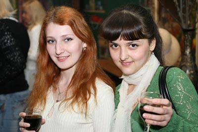  A photo of two beautiful Russian women, each holding a glass of wine